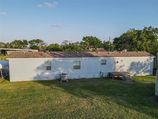 an aerial view of a house with a garden and yard