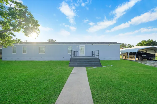 a view of a house with a back yard