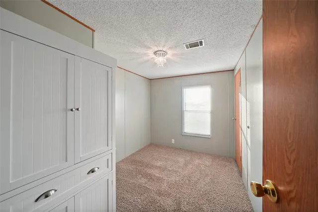 a view of empty room with window and ceiling fan