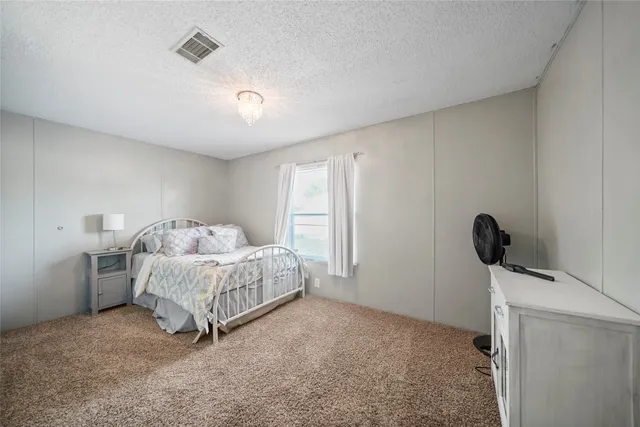 a living room with a bed furniture and a window