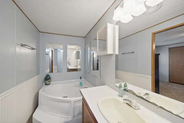 a bathroom with a sink a toilet a mirror and shower