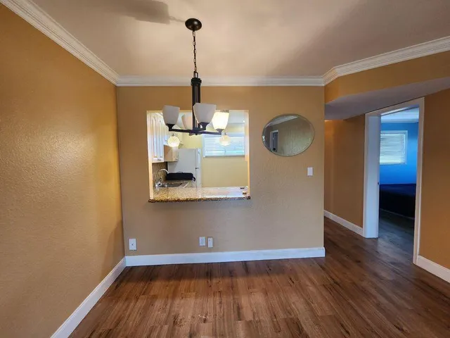 a view of a room with wooden floor and sink