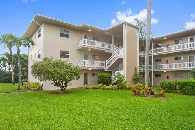 a front view of a house with a garden and plants