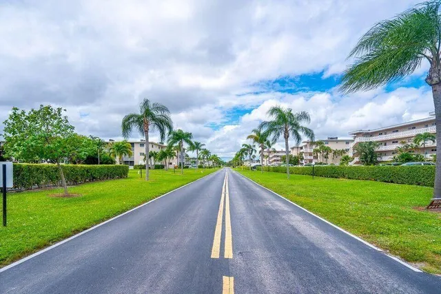 a view of a garden and front view of a house