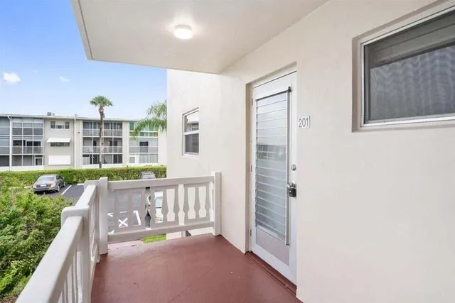 a view of a balcony with furniture