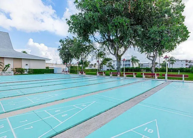 a view of a playground with basketball court