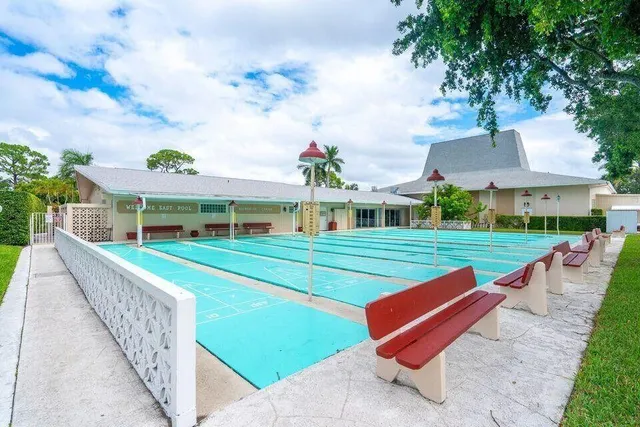 a front view of a house with a yard table and chairs