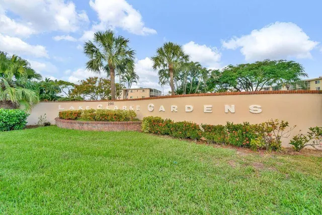 a view of a garden with a building in the background
