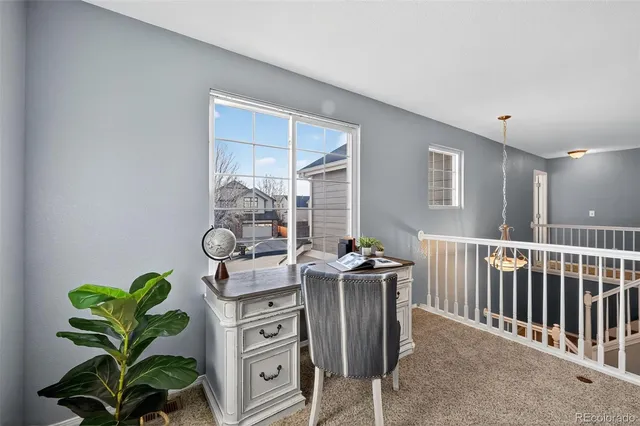 a dining room with furniture and potted plant