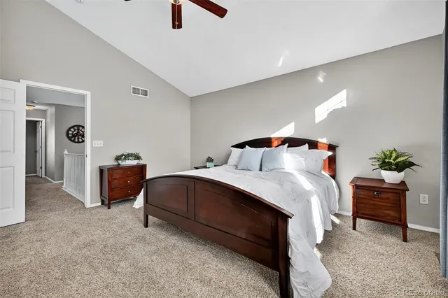 a bedroom with a bed and a potted plant