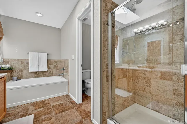a bathroom with a tub shower and sink