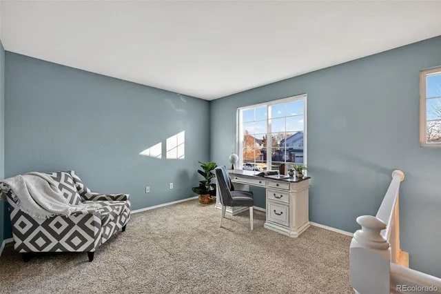 a workspace with furniture and window