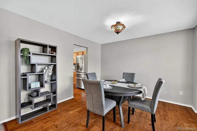 a view of a dining room with furniture and wooden floor