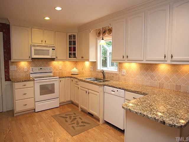 2713 Farnborough Road Raleigh, NC 27613 - Photo 3 of 6 a kitchen with granite countertop a sink stainless steel appliances and cabinets