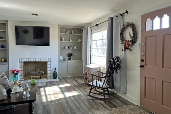 a living room with furniture a flat screen tv and a fireplace