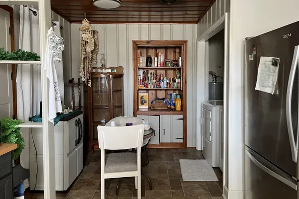 a kitchen with refrigerator and furniture