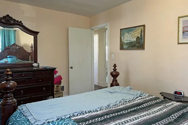 a bedroom with a bed and a dresser