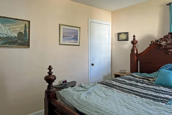 a bedroom with a bed and a dresser
