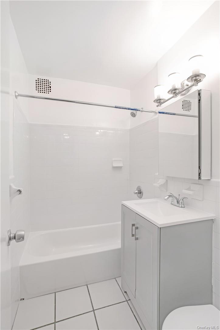 411 Bronx River Road, Unit 7F Yonkers, NY 10704 - Photo 14 of 23 a bathroom with a sink a toilet and shower