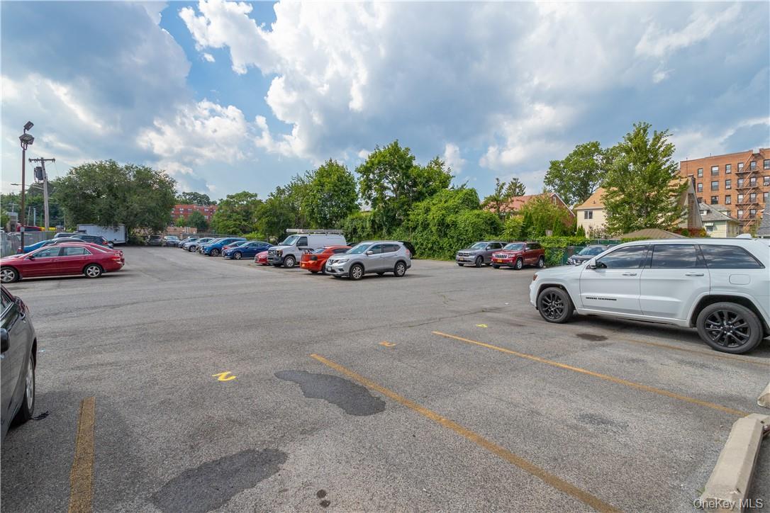 411 Bronx River Road, Unit 7F Yonkers, NY 10704 - Photo 19 of 23 a view of a cars park in front of a building