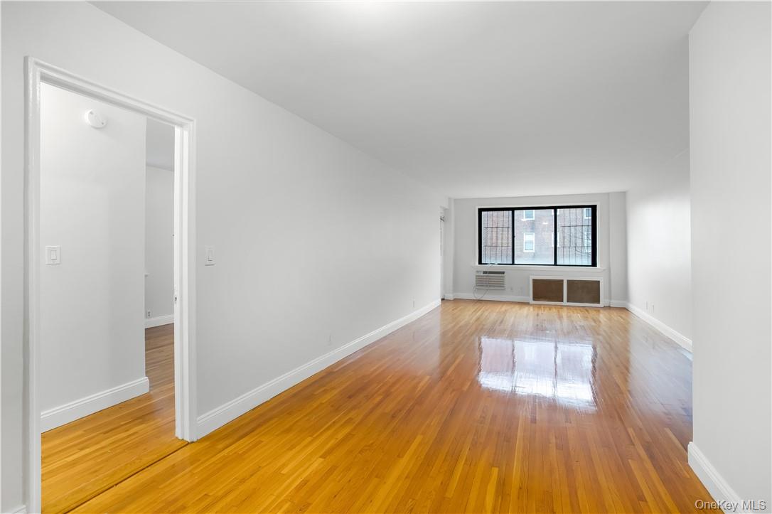 411 Bronx River Road, Unit 7F Yonkers, NY 10704 - Photo 4 of 23 wooden floor in an empty room with a window