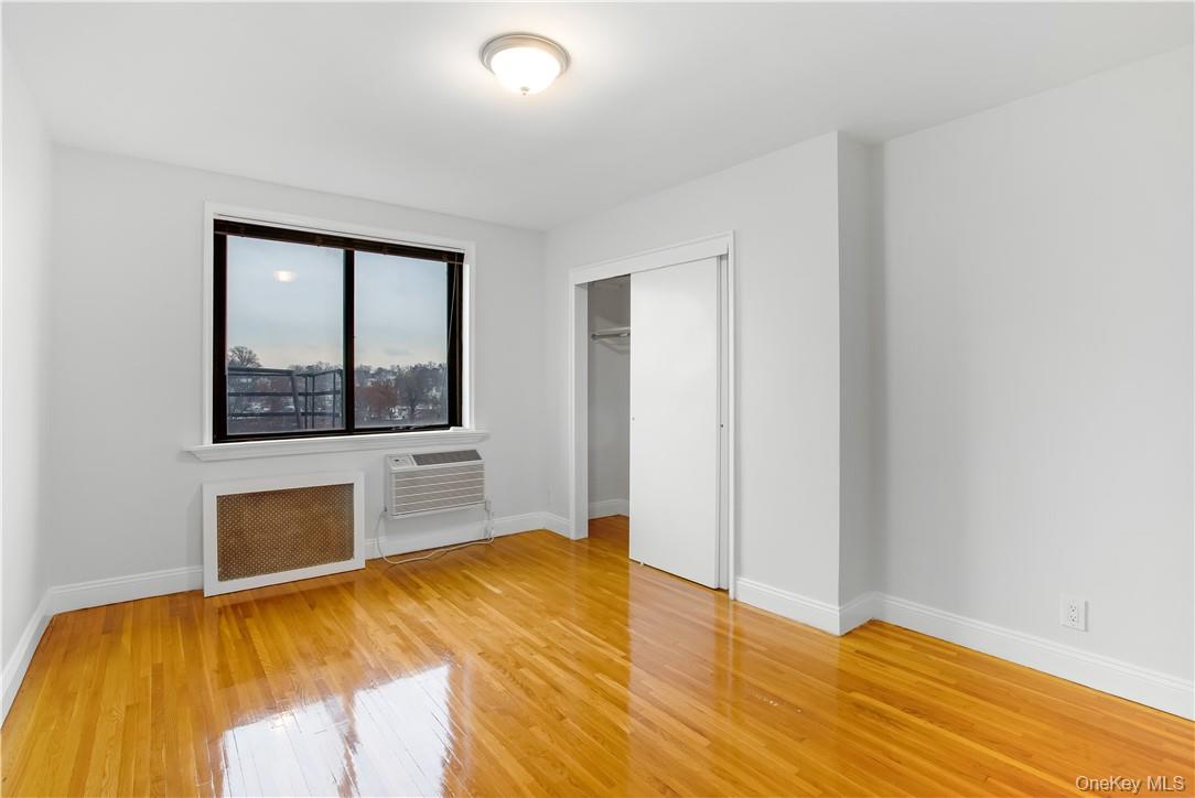 411 Bronx River Road, Unit 7F Yonkers, NY 10704 - Photo 6 of 23 a bedroom with a bed and a large window