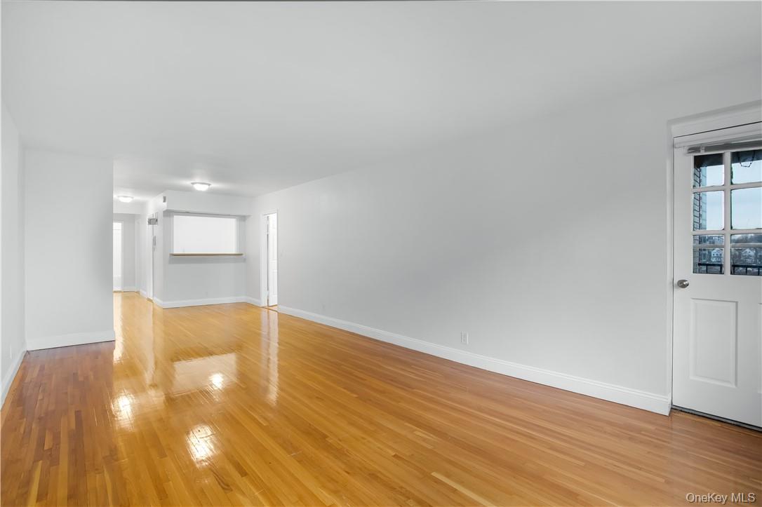 411 Bronx River Road, Unit 7F Yonkers, NY 10704 - Photo 9 of 23 a view of empty room with wooden floor and cabinet