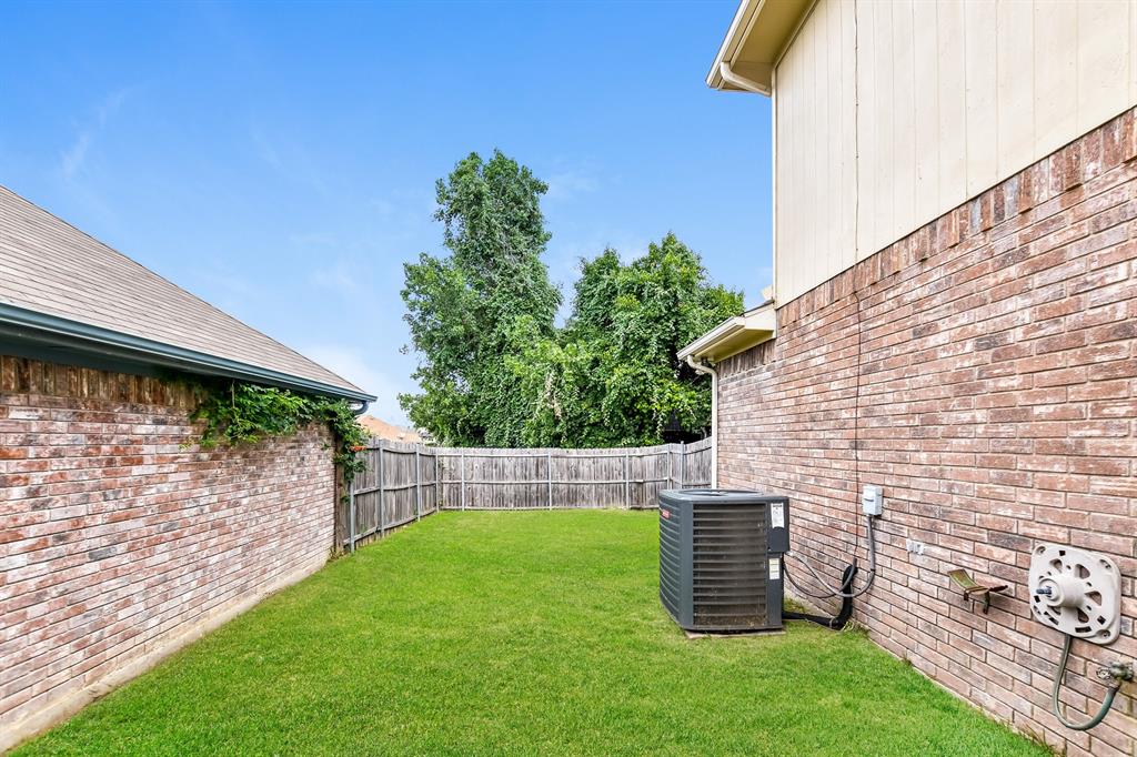 2425 Ithaca Drive Mesquite, TX 75181 - Photo 14 of 17 a view of a backyard with plants and a barbeque