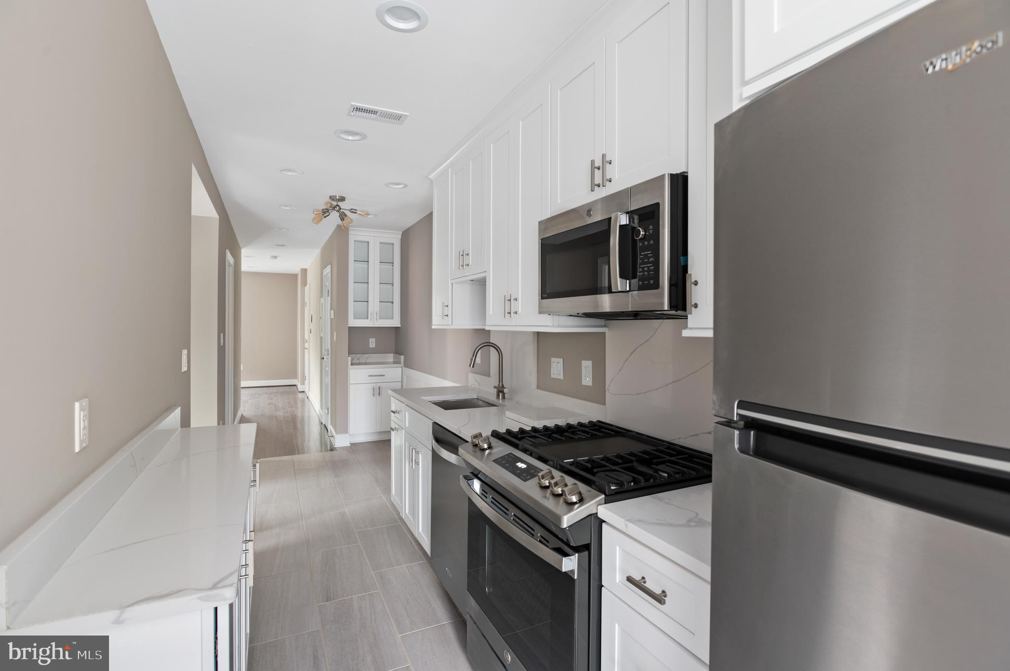 2215 40th Street Northwest, Unit 1 Washington, DC 20007 - Photo 11 of 21 a kitchen with a stove and a microwave