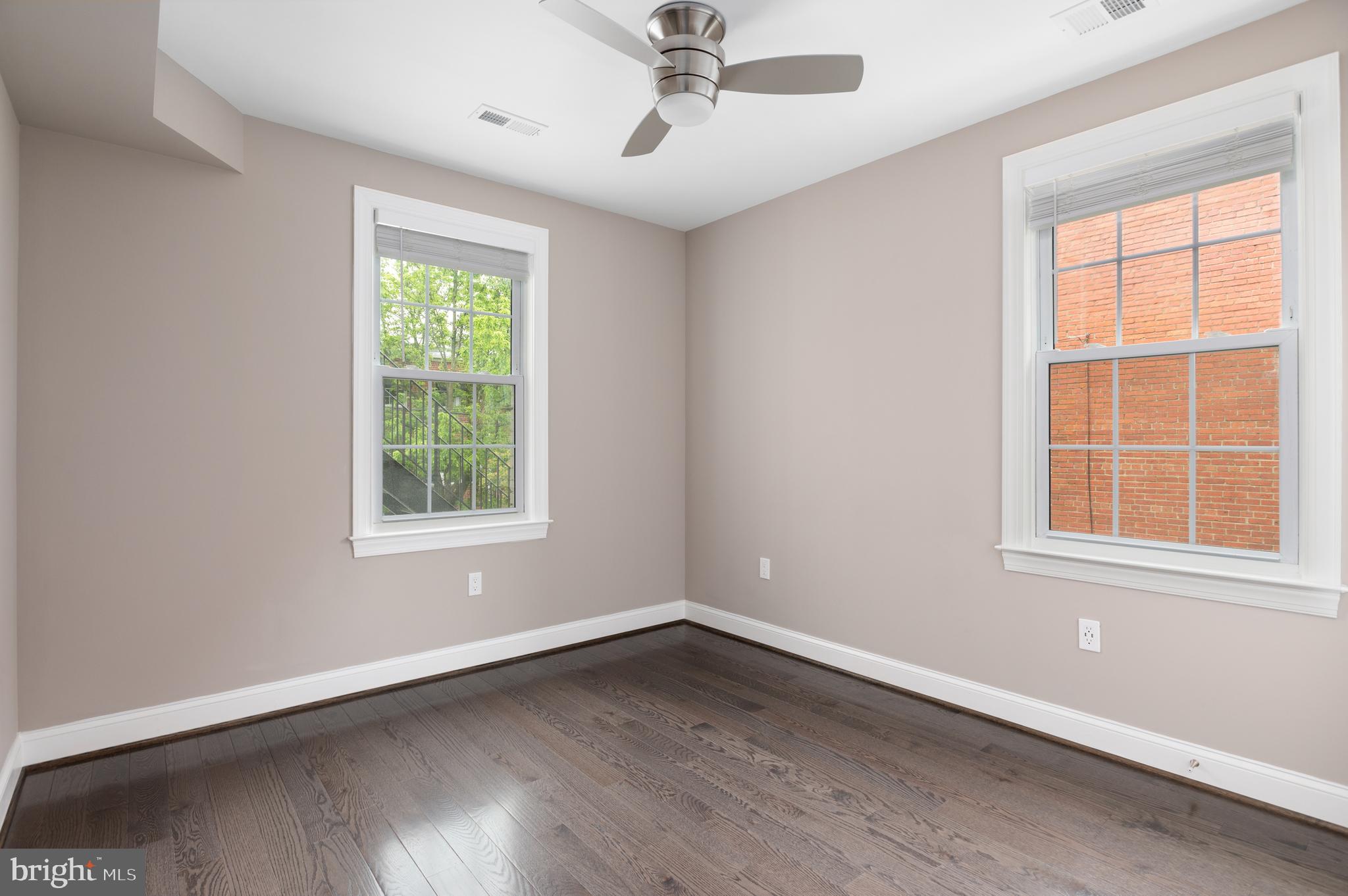 2215 40th Street Northwest, Unit 1 Washington, DC 20007 - Photo 12 of 21 wooden floor in an empty room with a window