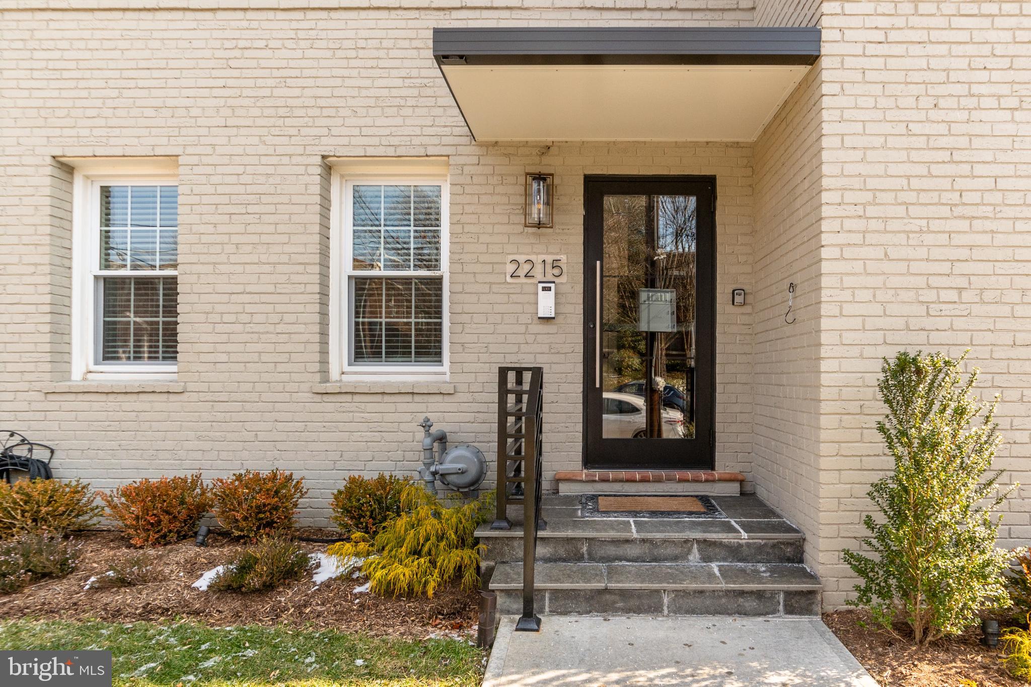 2215 40th Street Northwest, Unit 1 Washington, DC 20007 - Photo 3 of 21 a front view of a house with a yard