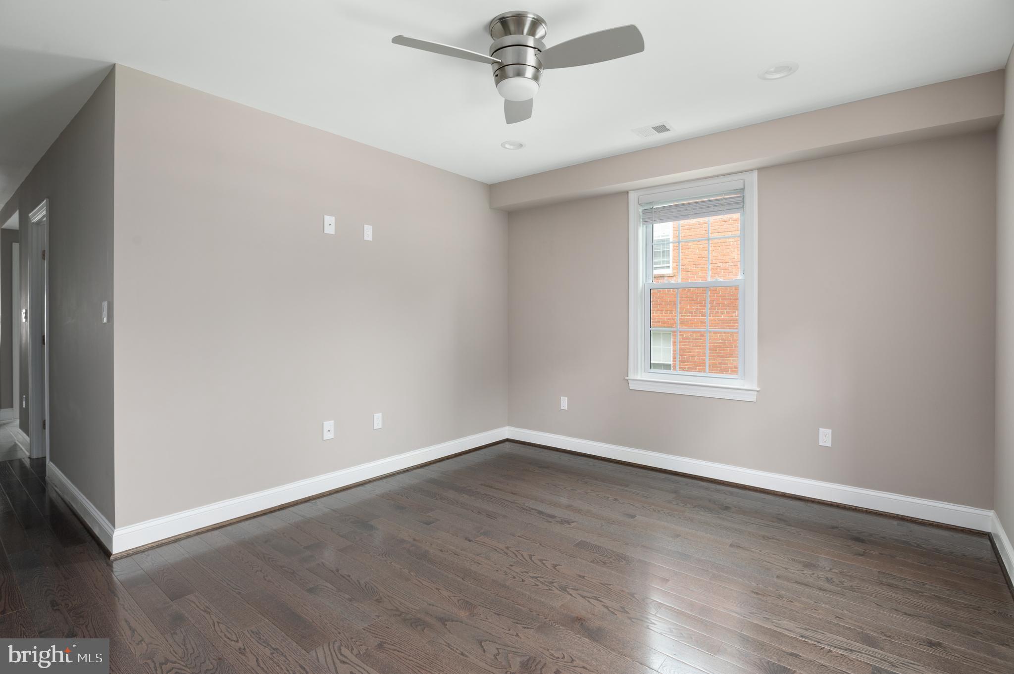 2215 40th Street Northwest, Unit 1 Washington, DC 20007 - Photo 4 of 21 wooden floor in an empty room with a window