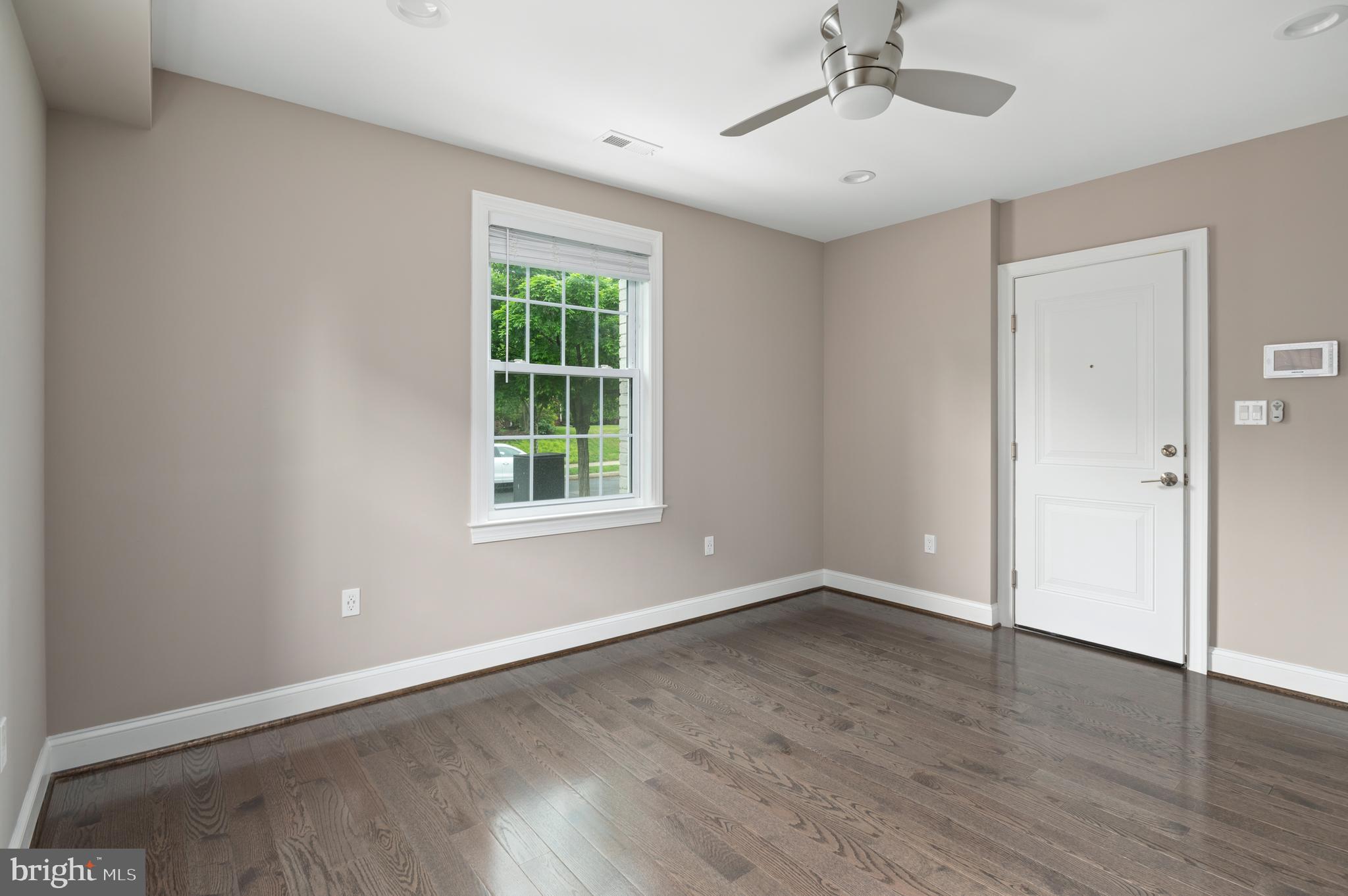 2215 40th Street Northwest, Unit 1 Washington, DC 20007 - Photo 6 of 21 a view of an empty room with wooden floor and a window