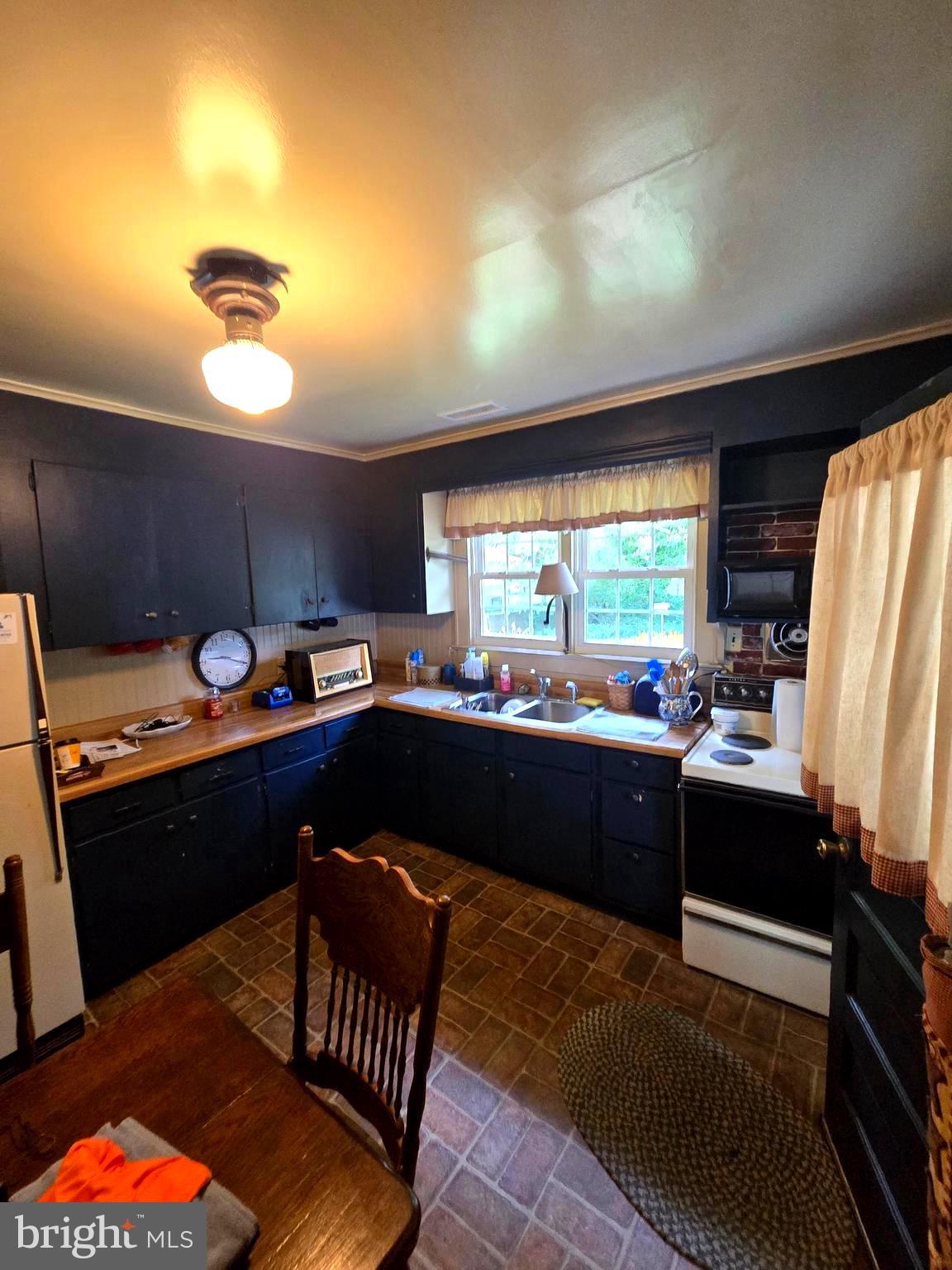 26431 Old State Road Crisfield, MD 21817 - Photo 12 of 25 a kitchen with a sink appliances and cabinets