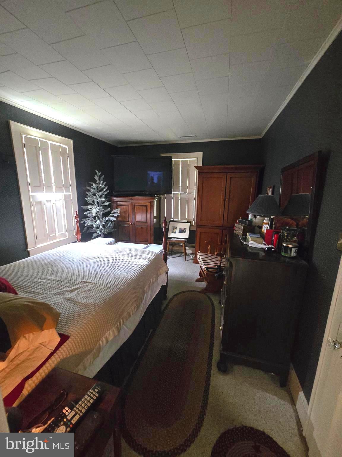 26431 Old State Road Crisfield, MD 21817 - Photo 15 of 25 a bed sitting in a bedroom next to a window