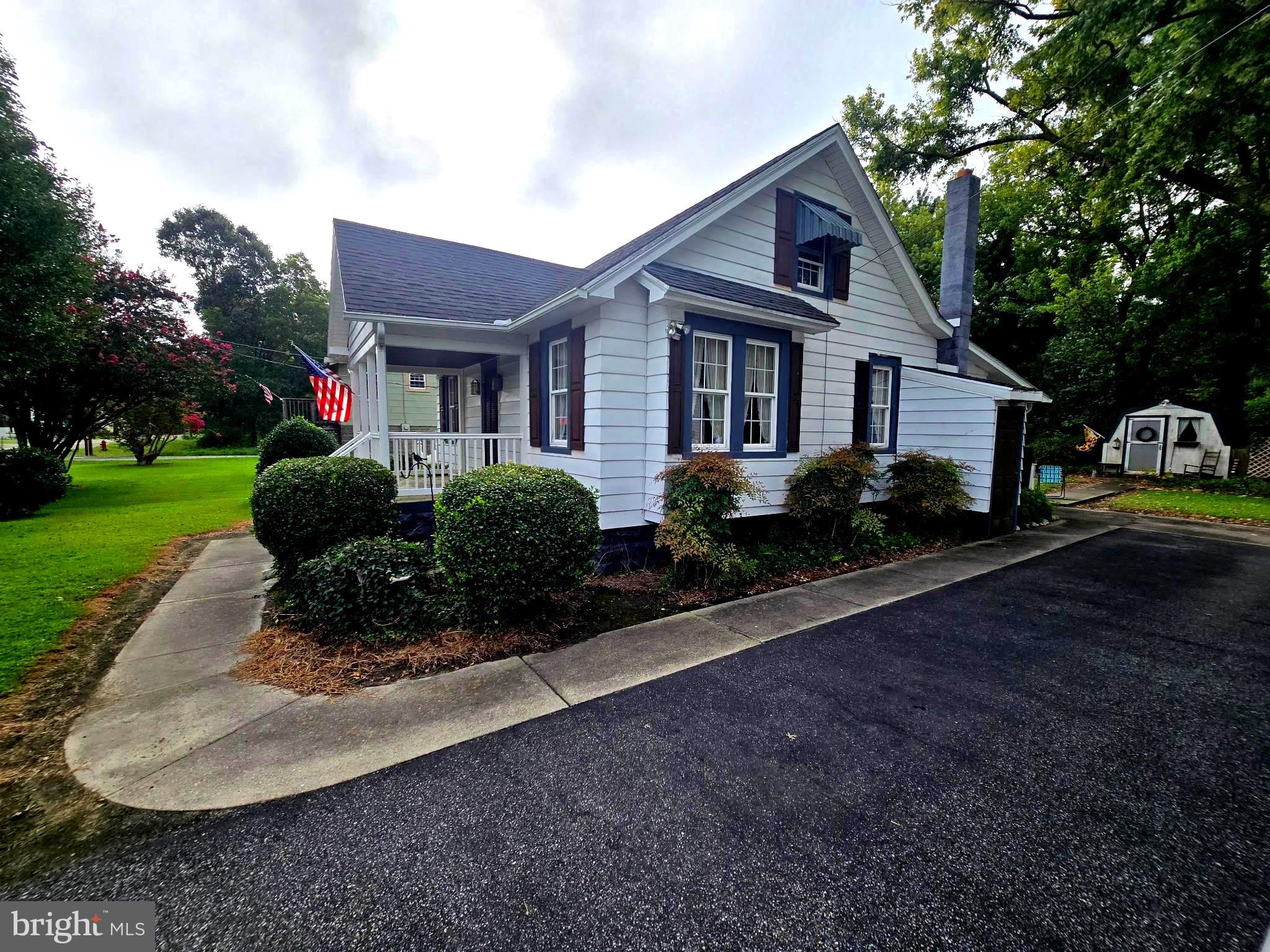 26431 Old State Road Crisfield, MD 21817 - Photo 5 of 25 a front view of a house with garden