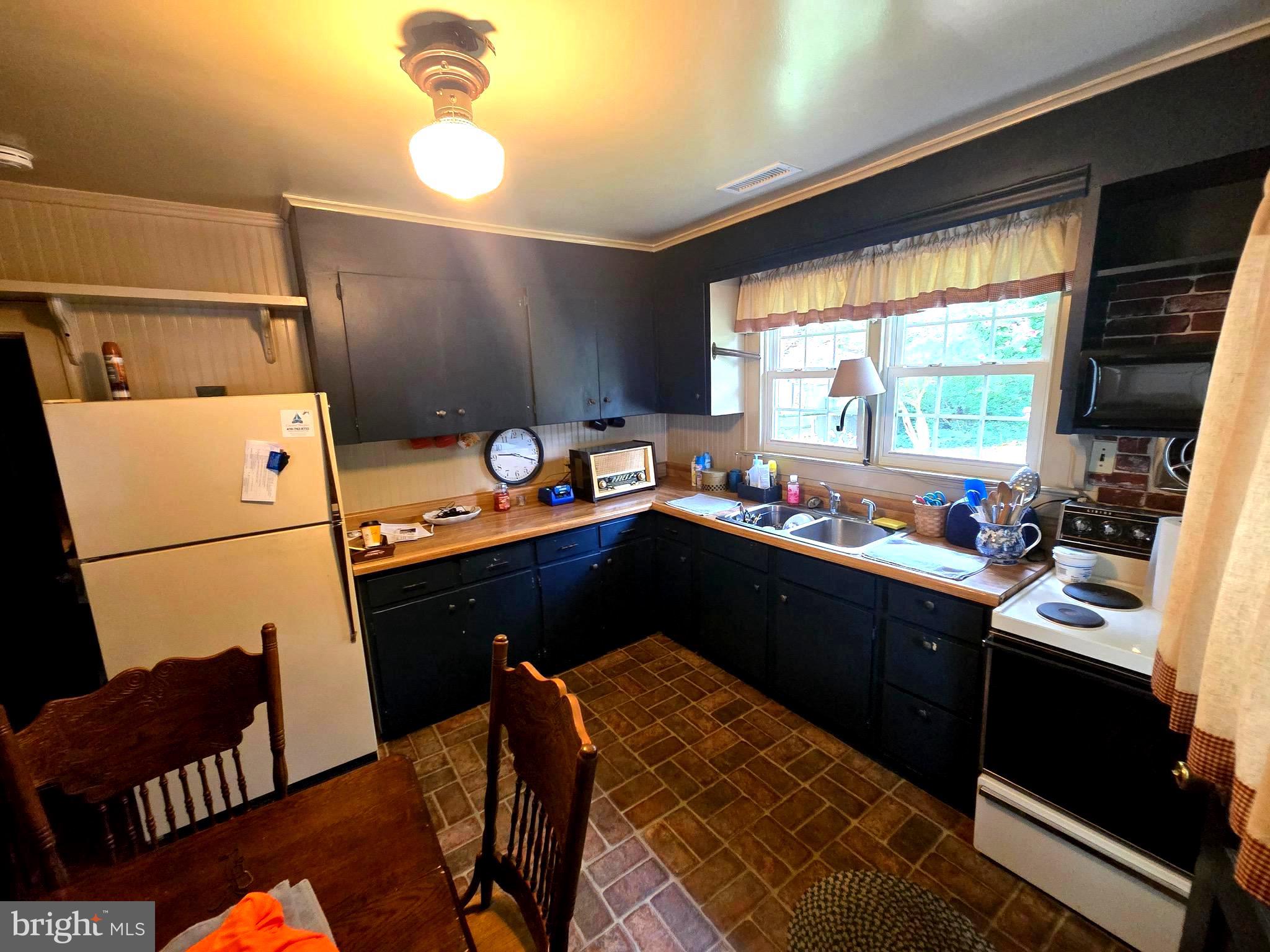 26431 Old State Road Crisfield, MD 21817 - Photo 8 of 25 a kitchen with a sink appliances and a window