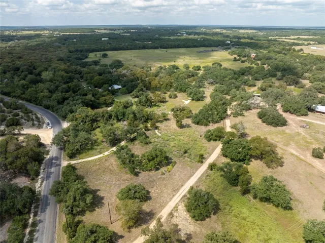 an aerial view of a houses with a lake