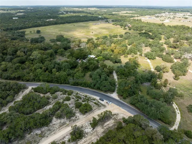 an aerial view of residential houses with outdoor space and river