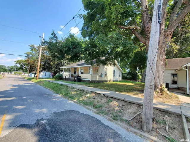 a view of a yard with a house and large tree