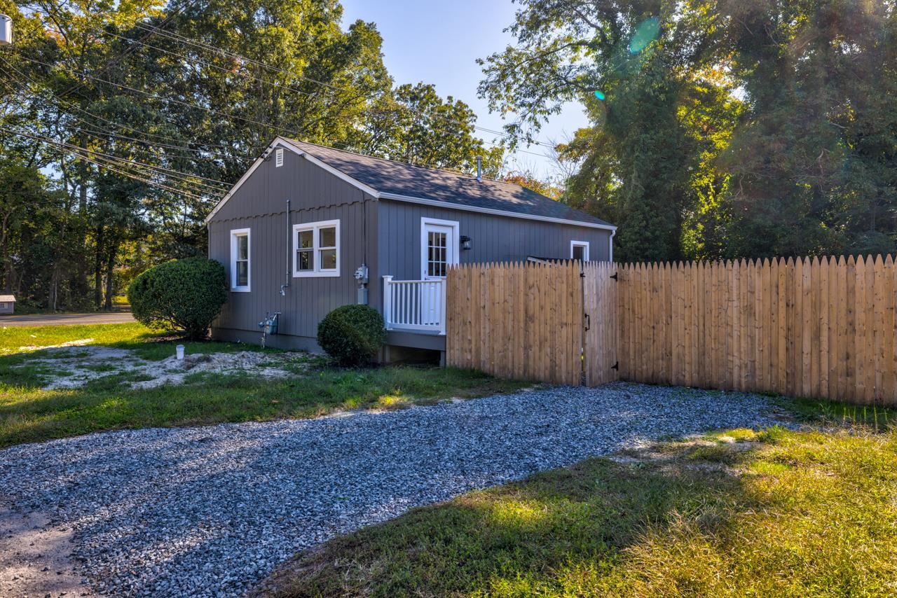 209 Breakwater Road Cape May, NJ 08204 - Photo 18 of 20 a view of a yard in front of a house with large trees