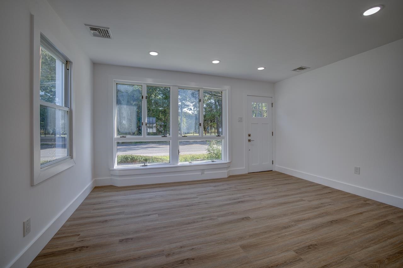 209 Breakwater Road Cape May, NJ 08204 - Photo 2 of 20 a view of an empty room with wooden floor and a window