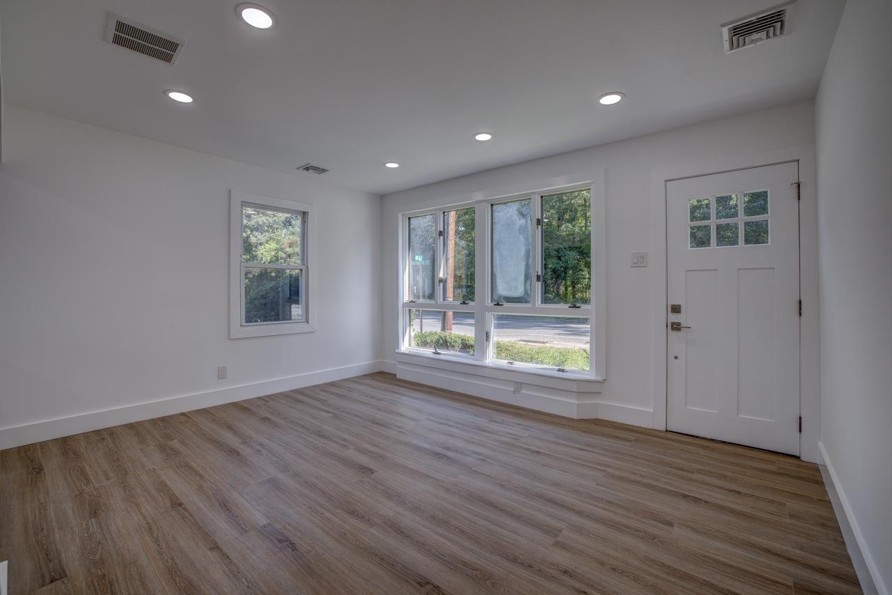 209 Breakwater Road Cape May, NJ 08204 - Photo 3 of 20 an empty room with wooden floor and windows