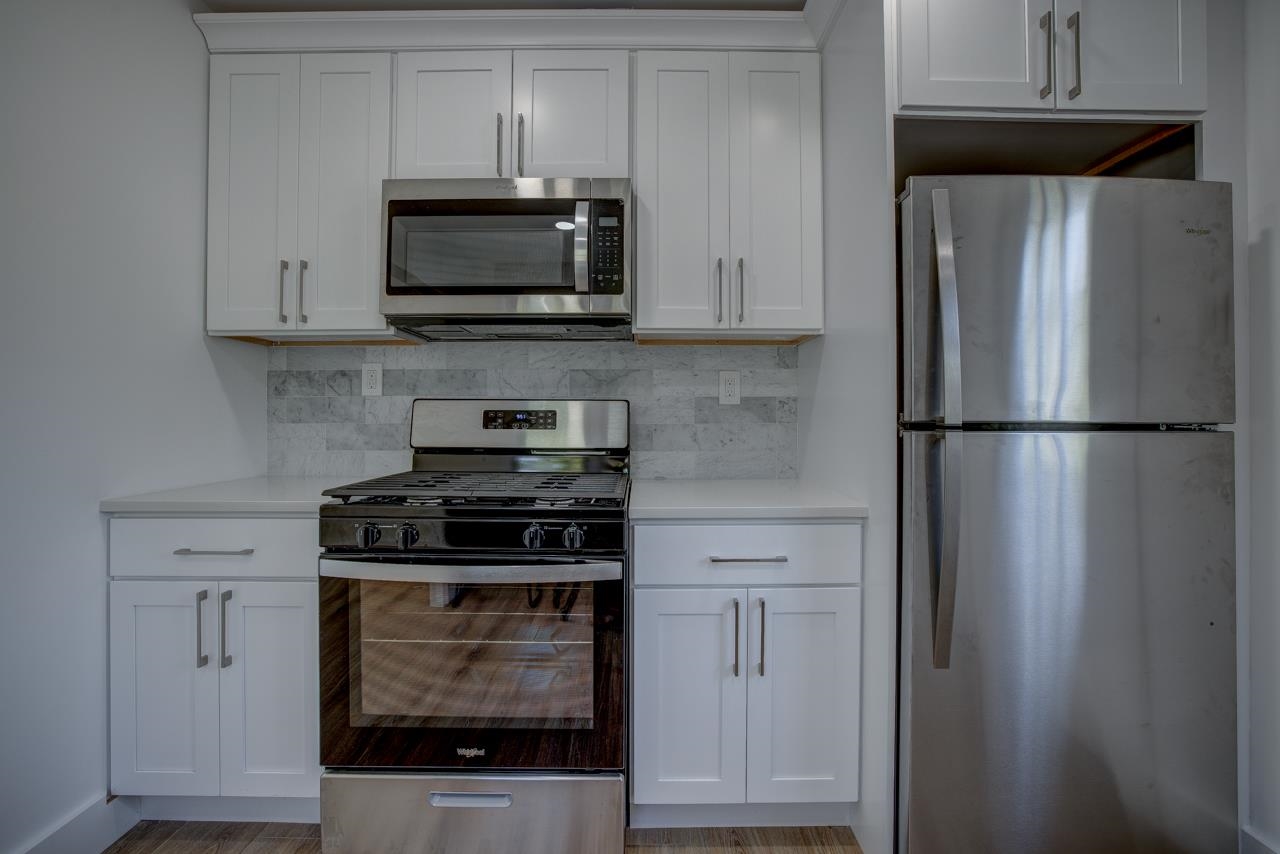 209 Breakwater Road Cape May, NJ 08204 - Photo 4 of 20 a kitchen with stainless steel appliances granite countertop a stove and a refrigerator with granite countertops