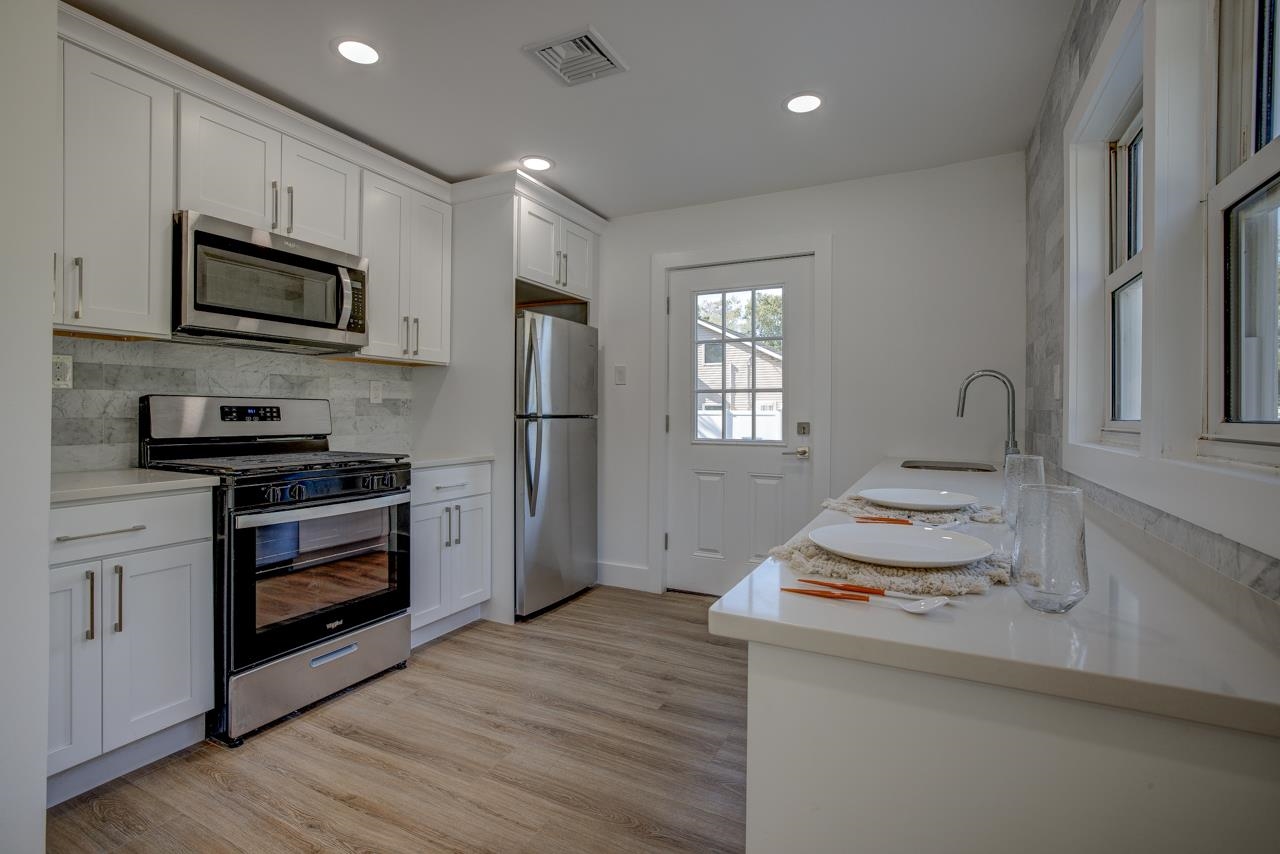 209 Breakwater Road Cape May, NJ 08204 - Photo 5 of 20 a kitchen with a sink stove and microwave