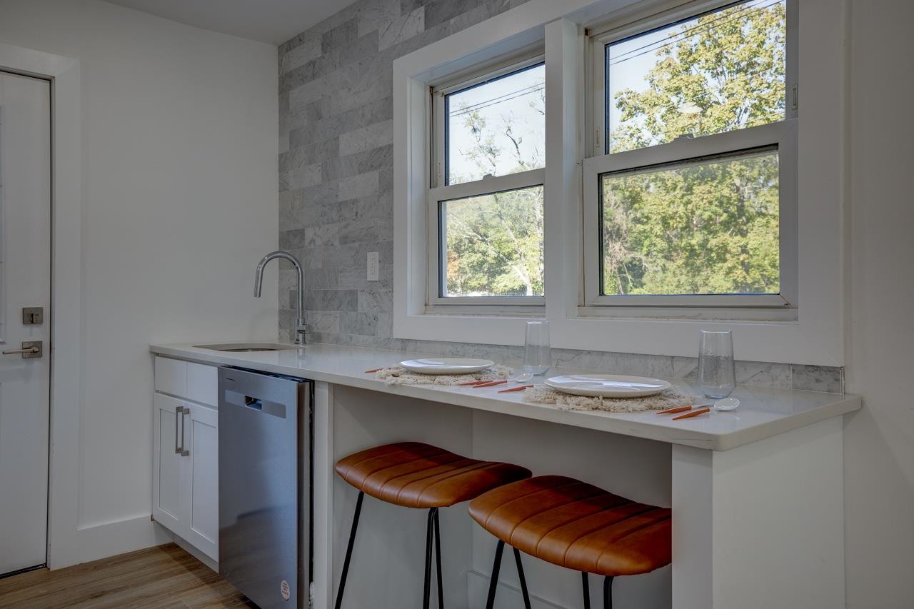 209 Breakwater Road Cape May, NJ 08204 - Photo 6 of 20 a dining room with a sink and a window
