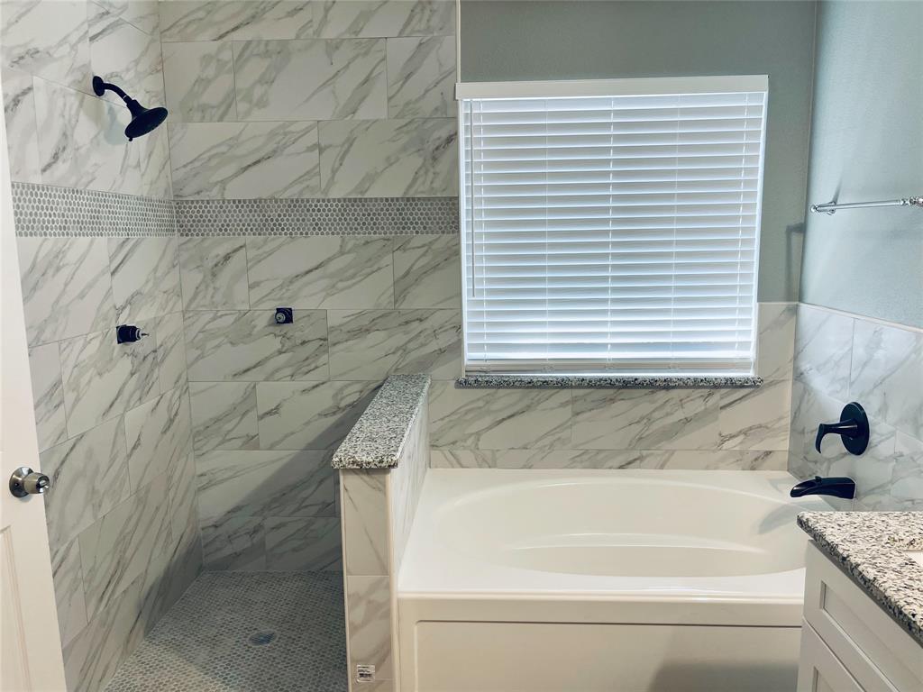 548 Kerry Street Crowley, TX 76036 - Photo 19 of 35 a bathroom with a granite countertop sink and a bathtub