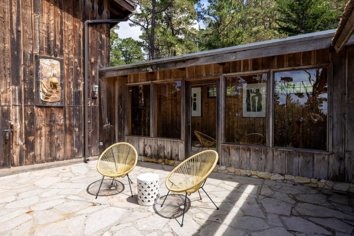 73 Mt Devon Road Carmel Highlands, CA 93923 - Photo 57 of 88 a view of a chair and fire pit in patio with wooden fence