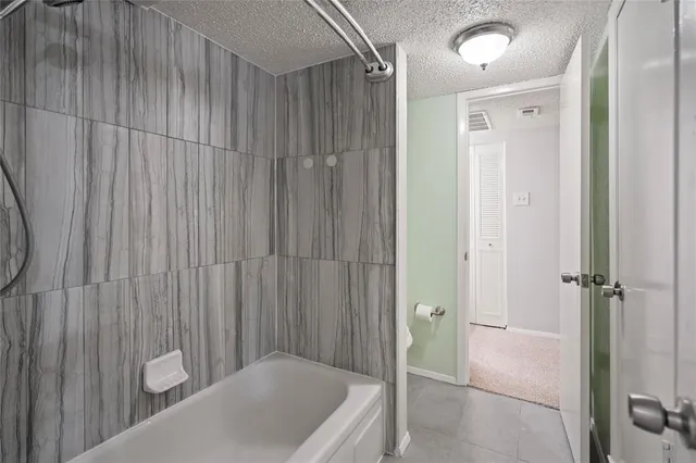 a bathroom with a tub and shower