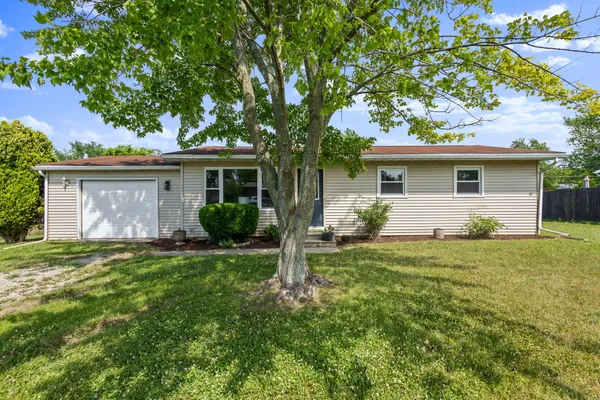 a front view of house with yard and green space